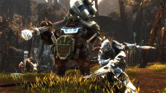 A warrior fighting an ogre with two daggers