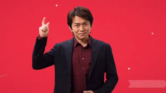 Yoshiaki Koizumi appears, holding his fingers together and snapping them to imitate the Nintendo Switch snap