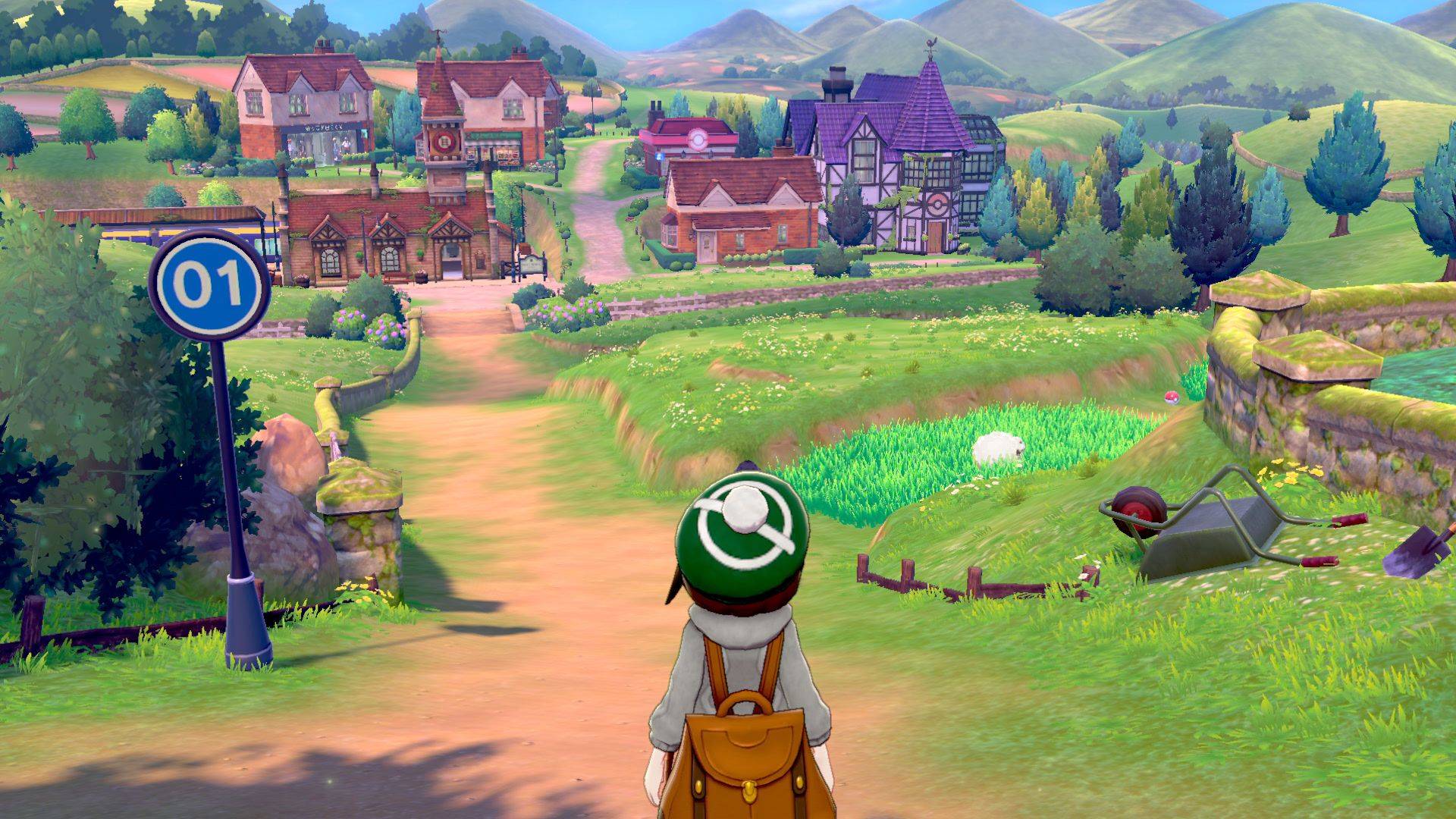 A pokemon trainer looks out over the countryside of Galar, with several routes and towns visible in front of them 