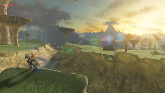 Link sits atop a horse, standing at the edge of a cliff. The sun is setting over a vista, and the mountains are visible through heavy fog