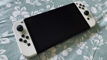 A Nintendo Switch OLED model with white Joy-Con