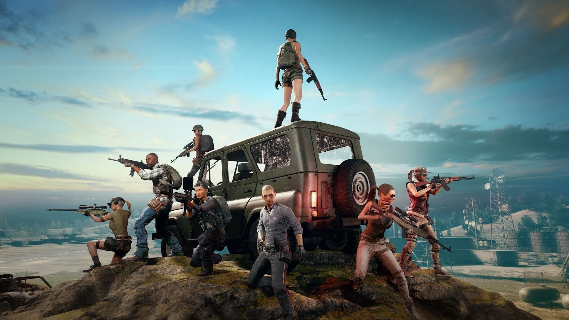 Best mobile shooters: PUBG Mobile. Image shows a series of characters in military and combat outfits, standing around a jeep holding weapons.