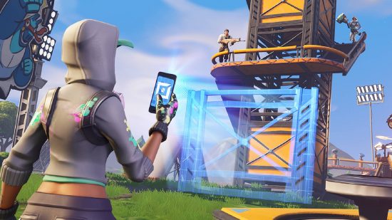 Fortnite creative: a Fortnite avatar holds up their phone to create a map