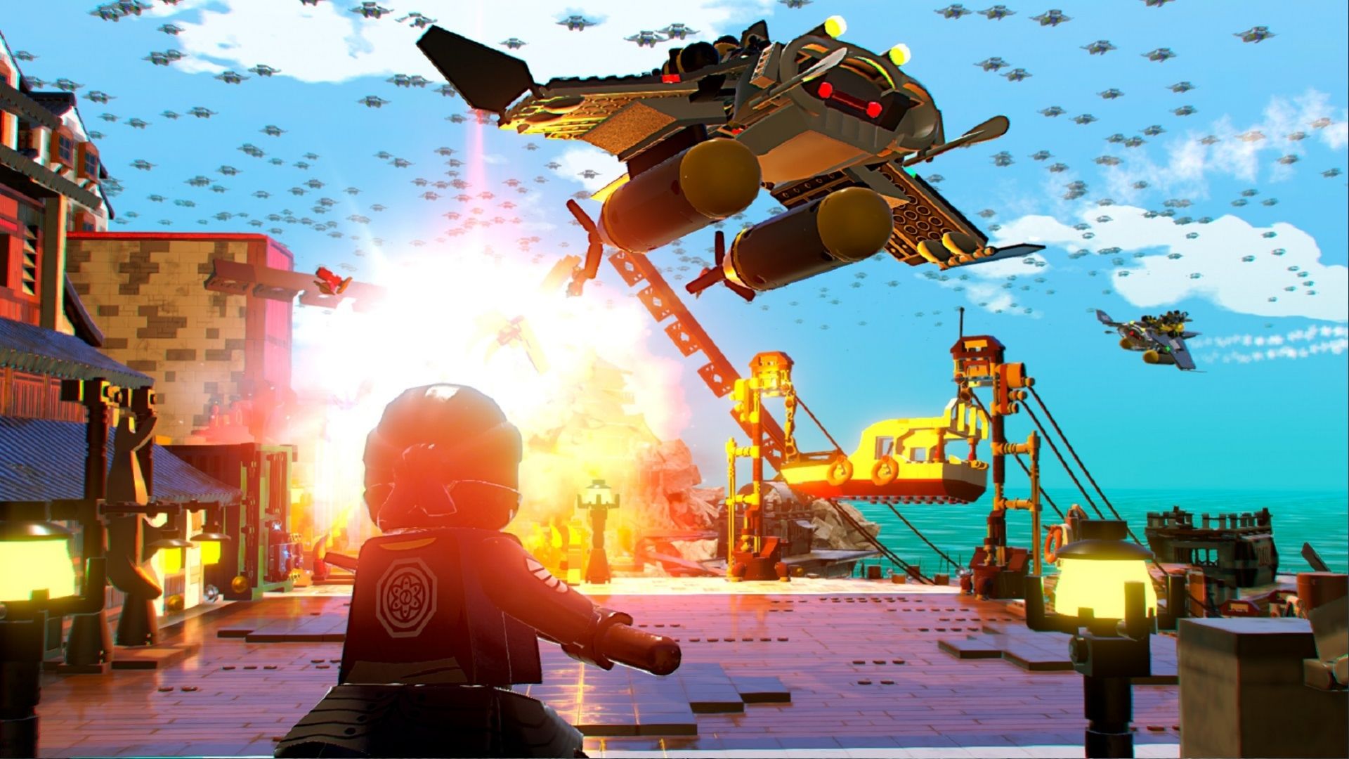 A ninja, one of The LEGO Ninjago characters, looking into the sky at a spaceship as a big explosion goes off behind it.
