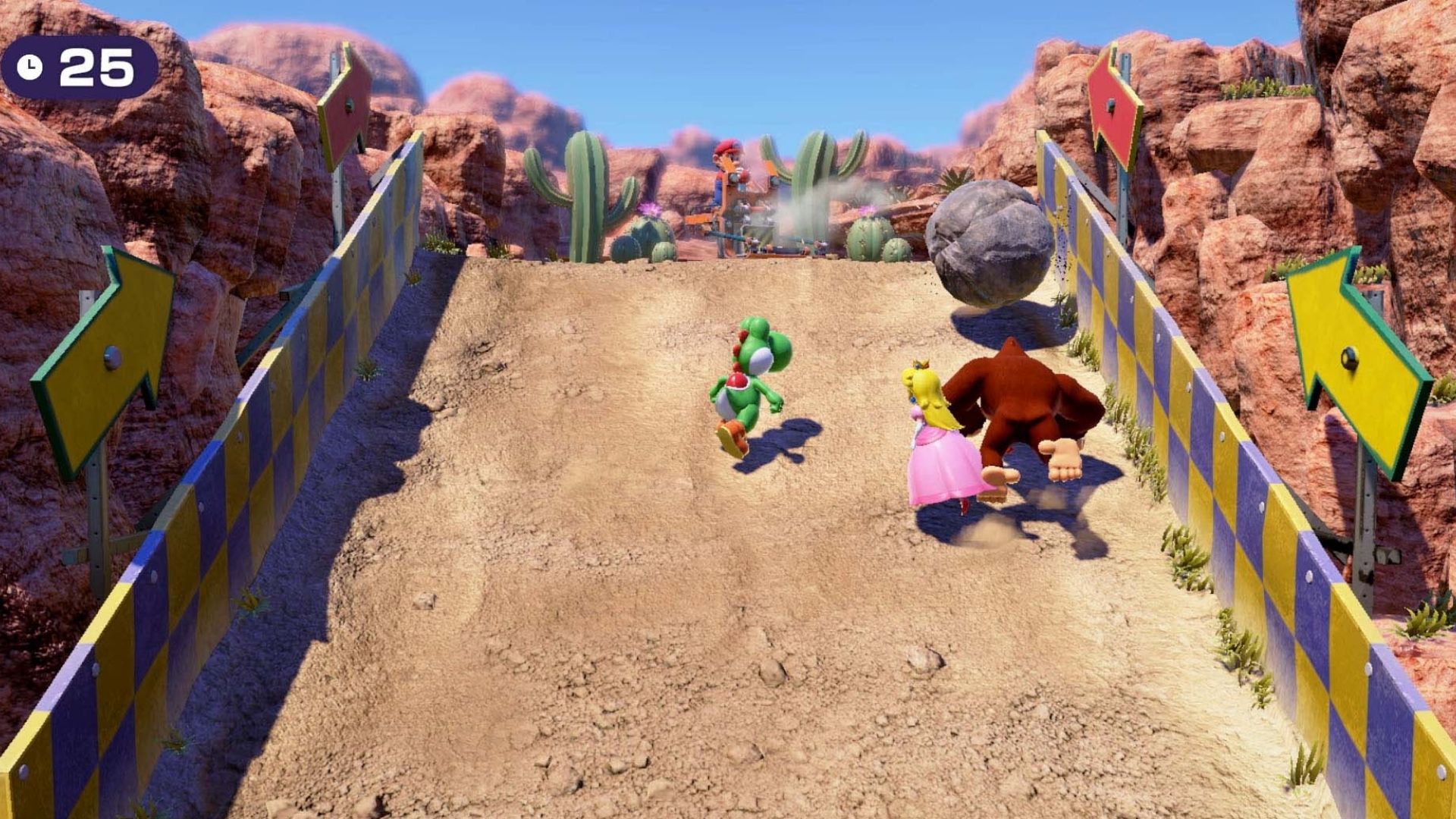 Yoshi, Donkey Kong, and Peach, running up a hill avoiding boulders in Mario Party Superstars.