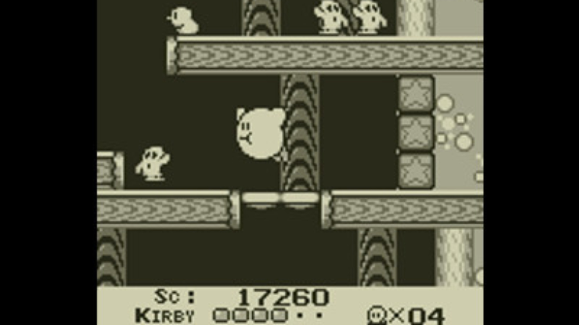 Best Kirby games: Kirby's Dream Land. Image shows Kirby flying inside a hollow tree.