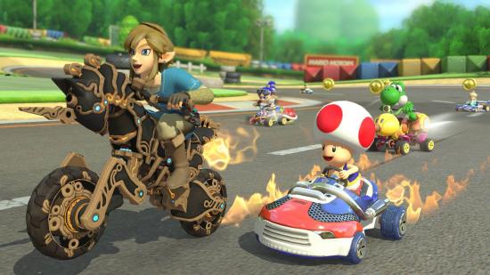 Mario Kart 8 characters: Toad rides a kart on a track while Link from The Legend Of Zelda rides on a bike next to him