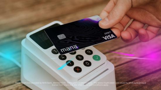 A close-up of the Mana debit card being used