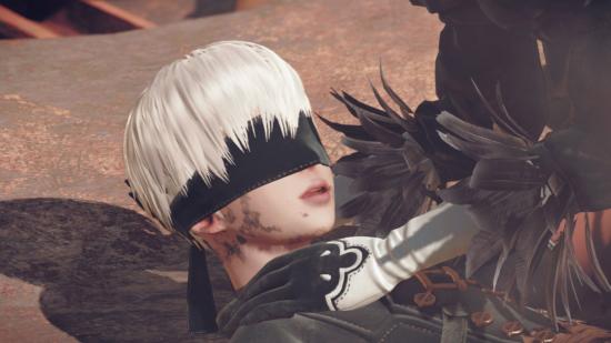 Nier Automata 9S lying on the floor injured, his head being cradled.