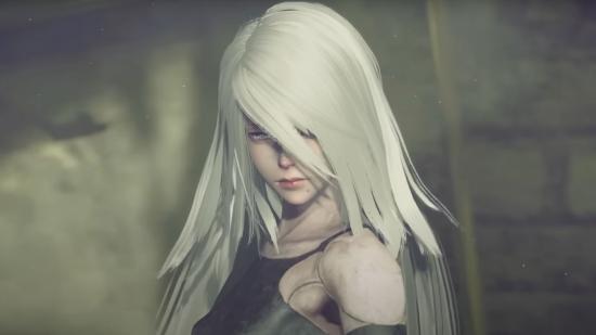 Nier Automata A2, close up, with long white hair over her face and a dusty sky in the background.