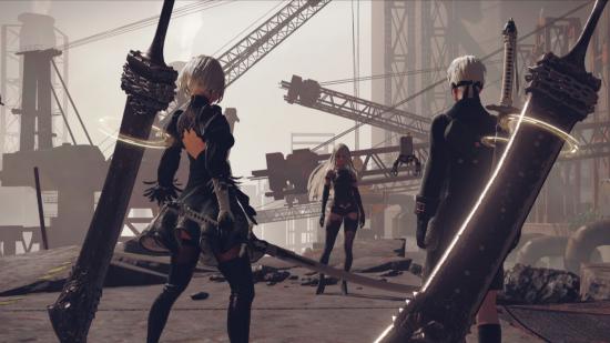 2B, 9S, and A2 from Nier Automata. 9S and 2B have their backs to us, swords floating behind them. They are in black outfits, both have white hair, with blindfolds over their eyes. Opposite them is A2, facing us, in a similar outfit but with longer white hair. They are surrounded by cranes and rubble.