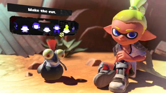 A tall Splatoon 3 hairstyle. Shown off by a character with grey shoes, yellow hair, sat in the desert with a cliff face behind them,and a small cute fish creature with an orange tuft of hair coming out the top of their head, and the menu options for choosing the hairstyle above.