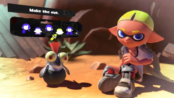 A short and smart Splatoon 3 hairstyle. Shown off by a character with grey shoes, yellow hair, sat in the desert with a cliff face behind them,and a small cute fish creature with an orange tuft of hair coming out the top of their head, and the menu options for choosing the hairstyle above.