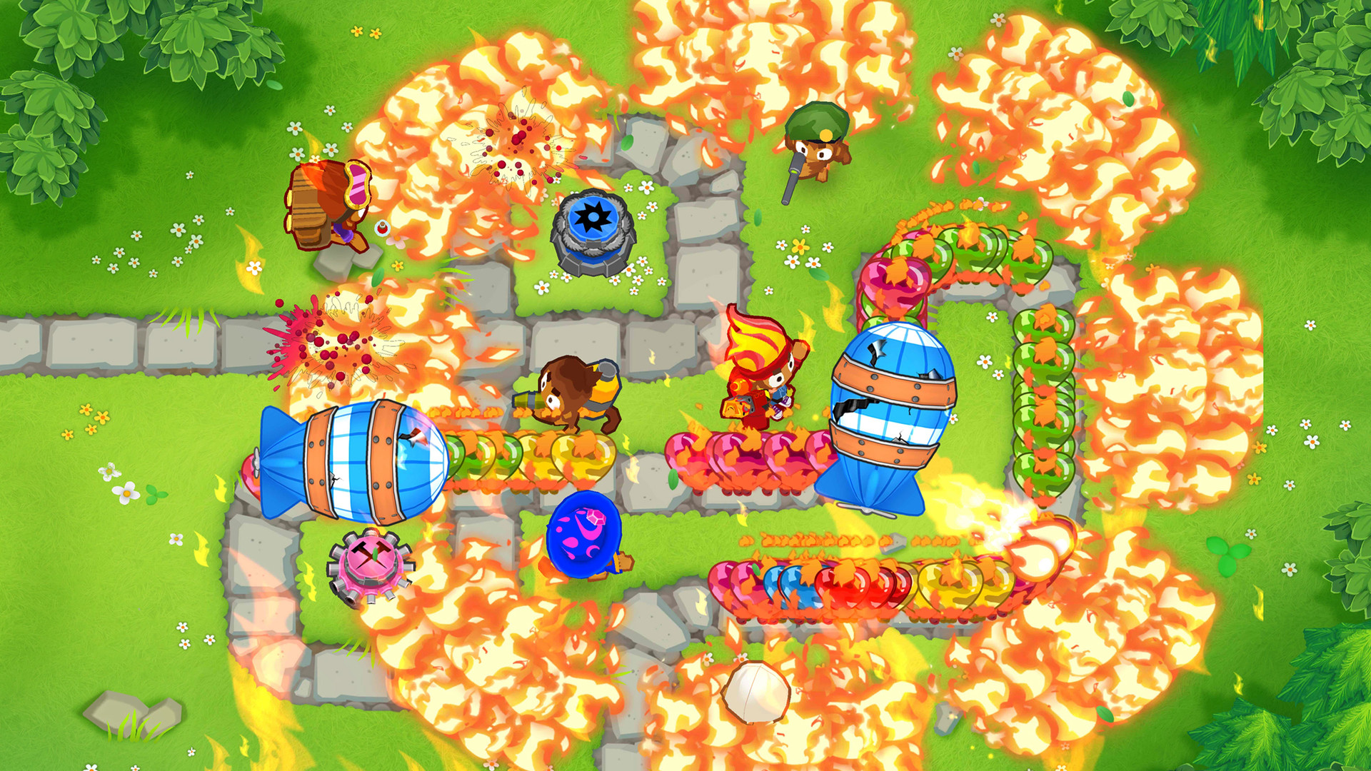 Best mobile strategy games: Bloons TD 6. Image shows characters walking around in a field and doing battle, all seen from a top down perspective.