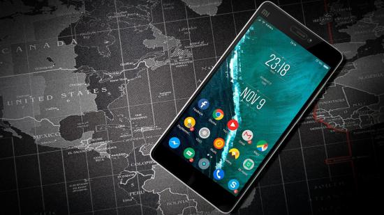 Best mobile VPNs, image shows a smartphone over a map of the world.