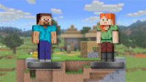 Two Minecraft amiibo on a blurred background showing a blocky Minecraft world. The amiibo on the left is Steve, a blue shirted man with brown goatee and hair. On the right is Alex, a ginger woman with a green shirt. They are both made out of blocks.