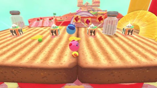 Kirby's Dream Buffet review: a small pink Kirby rolls around on a level made of toast