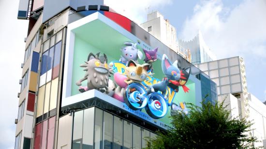 A group of cat Pokemon appearing in Pokemon Go 3D outdoor advertisement in Shinjuku