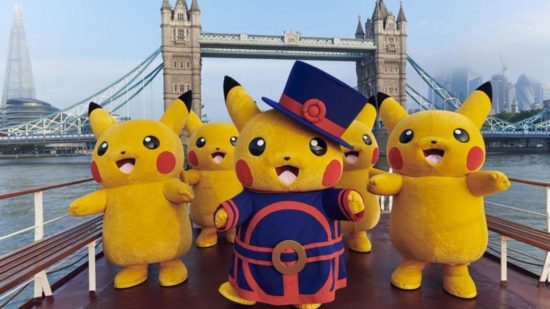 Various people in Pikachu outfits on a boat in front of Tower Bridge in London.
