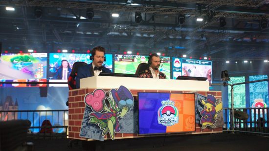 Pokemon Worlds 2022: two presenters sit behind a desk, live casting a Pokemon match