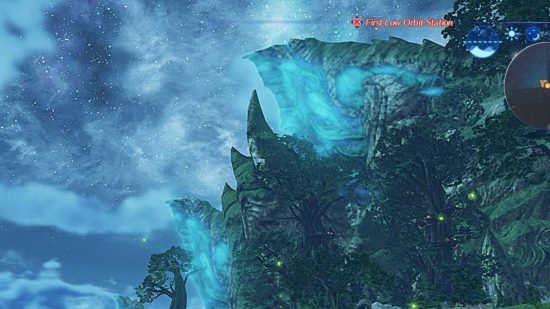 A screenshot from Xenoblade Chronicles 2 showing a glowing blue outcrop in the distance behind some tall pine trees.