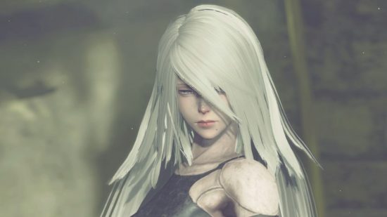 A2 from Nier Automata, a close up of her face. She has silver hair covering half of it, bare shoulders coming out of a black bodysuit-type thing.