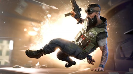 A guy jumping over a desk with a gun and into the Rainbow Six Mobile closed beta