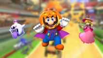 Mario Kart Tour Halloween costumes on a blurred background of a Mario Kart course. In the middle is Mario, wearing a cape and pumpkin on his head, on the right is Peach, dressed as a witch, and on the left is Boo, a ghost with a large blue tongue sticking out.