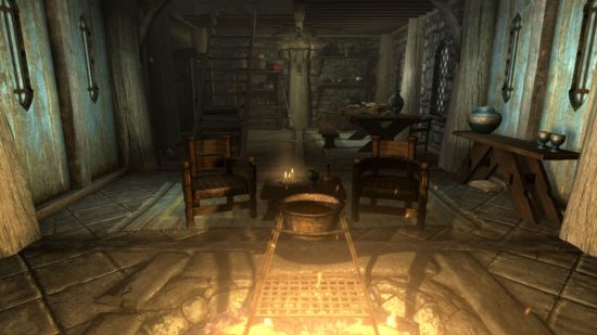 Skyrim marriage: a fire pit sat in the middle of an old-timey house with chairs around it and a cooking pot above it in a screenshot from Skyrim.