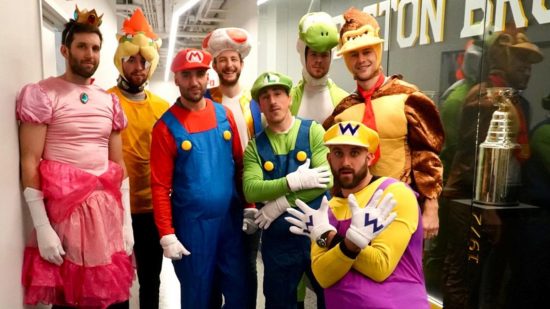 Screenshot of the Boston Bruins heading to a children's hospital ward in Mario Halloween costumes