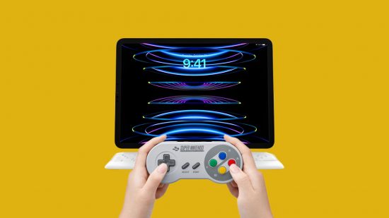 An SNES controller held in front of an iPad floating on a Magic Keyboard stand, to show that Nintendo retro controllers now work on Apple devices. It is shown on a yellow background.
