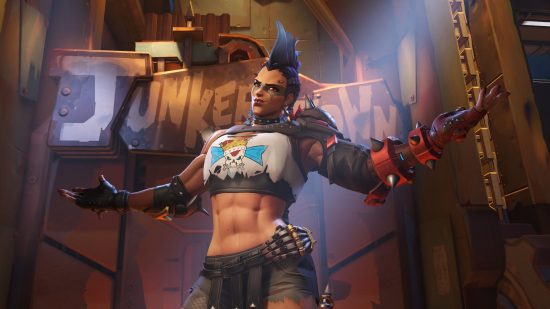A picture of Junker Queen, a character from Overwatch, screaming (to represent anger at the Overwatch 2 launch). She is a muscular woman in ragged clothing like a Mad Max character, she has a blue Mohawk, a shotgun-type weapon with DIY attachments, and spiky shoulder pads.
