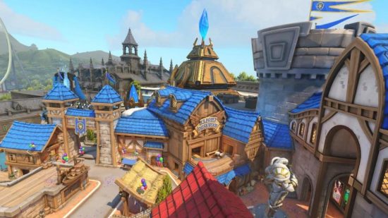 A scene from an Overwatch 2 map, showing various quaint buildings with blue and red roofs.