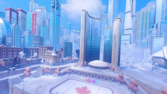 An Overwatch 2 map showing a scene showing a large square with the maple leaf on the floor in the middle, and bright white skyscrapers bordering it.