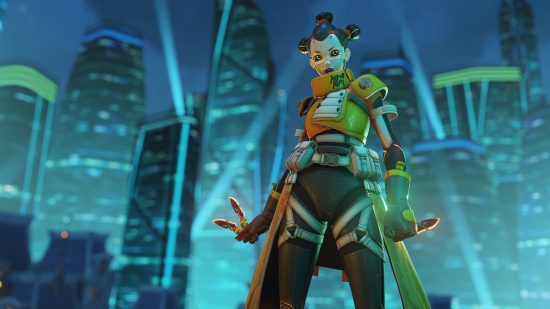 A unique skin for Kiriko for the header image of Overwatch 2 phone number guide. Kirk is in a futuristic city, wearing a white mask, yellow gown, and black military wear underneath. Her hair is black and arranged in three buns.