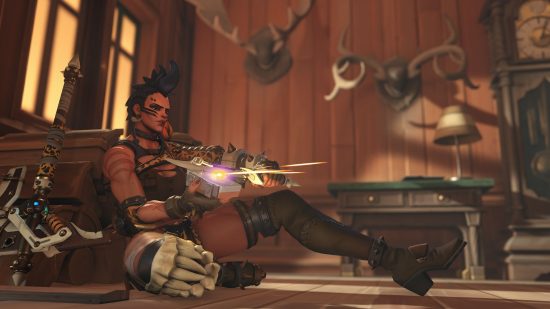 The Junker Queen with her Overwatch 2 weapon sat in a wooden walled room with deer heads mounted on the wall.