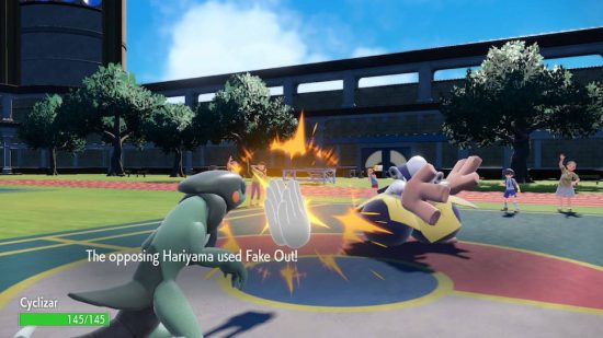 Pokemon Scarlet and Violet items: A Pokemon Scarlet and Violet screenshot shows Hariyama hitting Cyclazar with a fake out