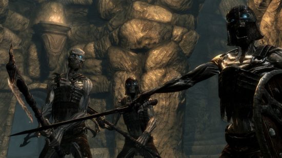 Skyrim Lydia: three skeletons stood in ragged armour wielding makeshift weapons in a stony dungeon in a screenshot from Skyrim.