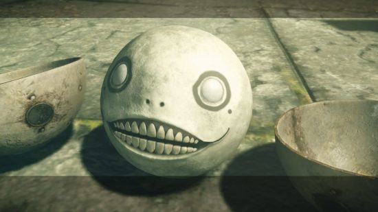 The Emil mask from Nier Automata, a spherical head with a grin and wide eyes.