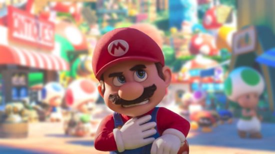 Mario movie plans: Mario from the Mario movie: red-hatted, moustachioed, blue-dungareed, white-gloved, and grimacing. The background is blurred, showing various Mario things.