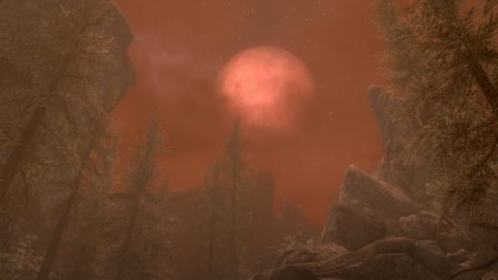 Skyrim werewolf: a red moon is big in a red sky above tall pine trees.