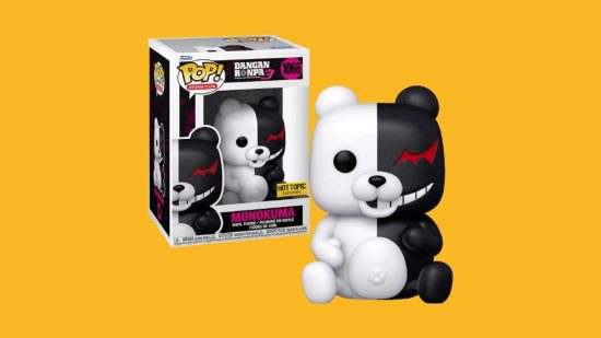 A Danganronpa figure on a yellow background. It's a bear, half white, half black, with a creepy cracked smille on one side and jagged red eye.