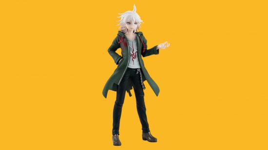 A Danganronpa figure on a yellow background. It's a boy in a long green jacket with spiky white hair and one hand out like he's talking.