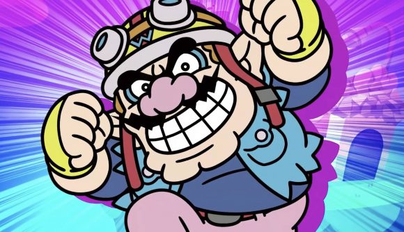 Wario is pictured enthusiastically punching the air, wearing his WarioWare biker outfit