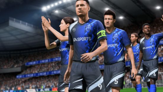 FIFA 23 tactics: a crowd of footballers in ablue and black kit walk onto a pith, some clapping, one waving, with the sponsor EA SPORTS emblazoned on their bellies.