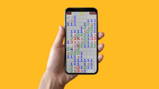 Play Minesweeper - a hand holding an iphone with Minesweeper on the screen