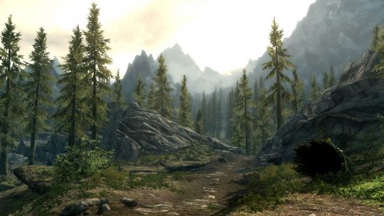 Skyrim dragon: Tall pine trees line a dusty path with dotted stones and a stony mound ahead, with tall, silhouetted mountains below a golden sky