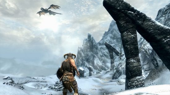 Skyrim thieves guild: A dragon flues in a wintry sky above a large mountain pass on which a horned-helmeted soldier stands in a screenshot from Skyrim.