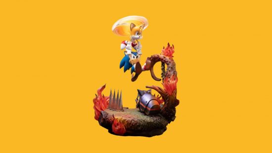 Sonic figures: Sonic is a blue hedgehog, with red shoes and white gloves. Here, he is holding onto Tails' hands (a yellow fox-looking cartoon character), over a fiery, volcano-style platform.
