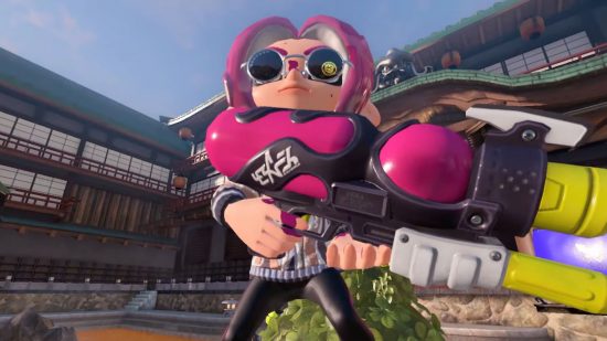 A Splatoon 3 update character in round sunglasses, holding a large pink water gun-type weapon and pink hair like tentacles.